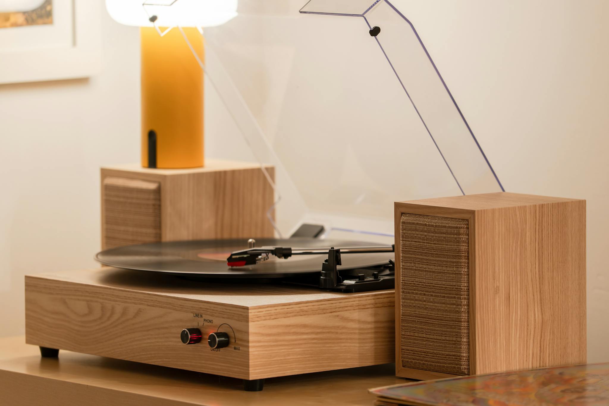 Close-up of a vintage turntable spinning a vinyl record with a stylish hi-fi setup.